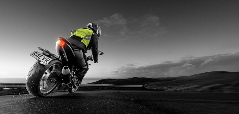 Two people riding motorbikes in a rural setting.