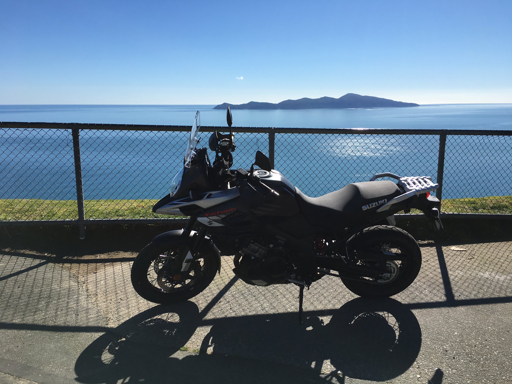 Motorcycle parked in front of water