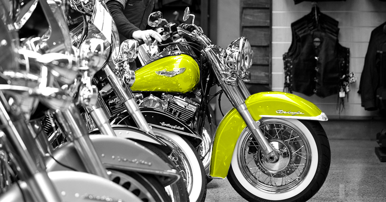 Black and white image of motorbikes with yellow accents