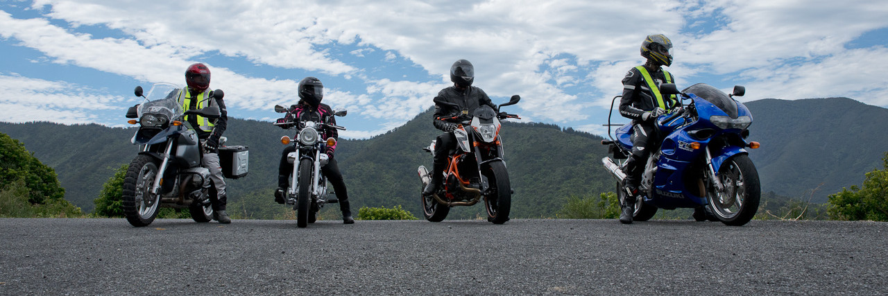 Four motorcyclists sitting on their bikes