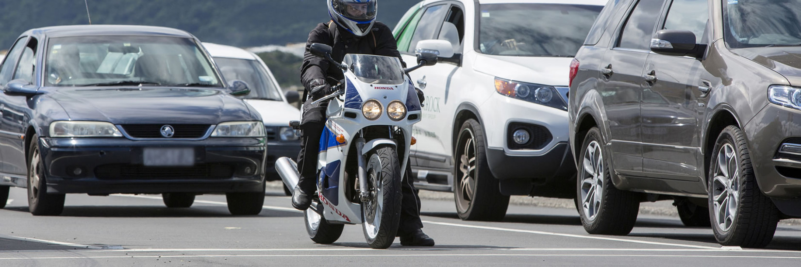 Motorcyclist at front of queue waiting for traffic lights