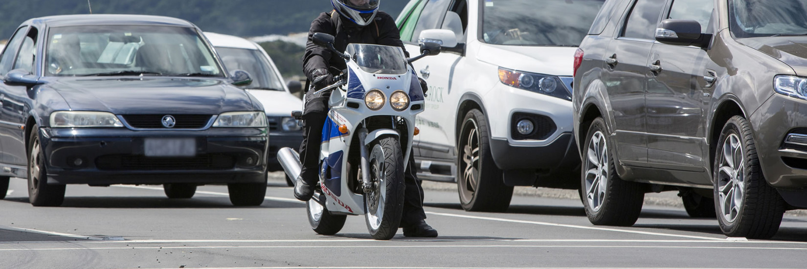 Motorcyclist at front of queue waiting for traffic light