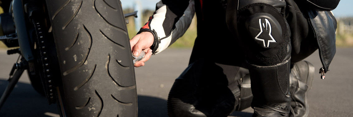 Close up of person checking tyres