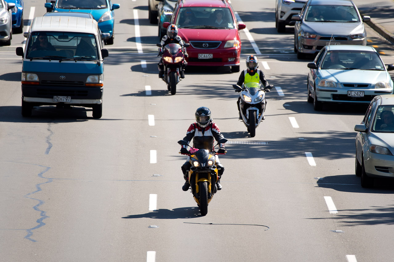 Motorbikes and cars in lanes