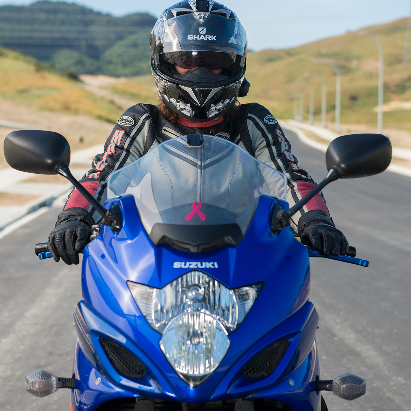 Close up of front of bike with motorcyclist riding