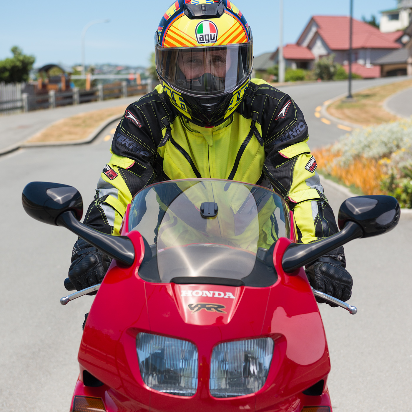 Close up of front of a red sport/performance bike with rider