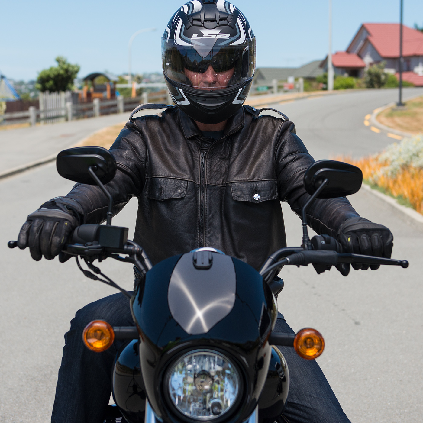 Close up of the front of a cruiser bike with rider