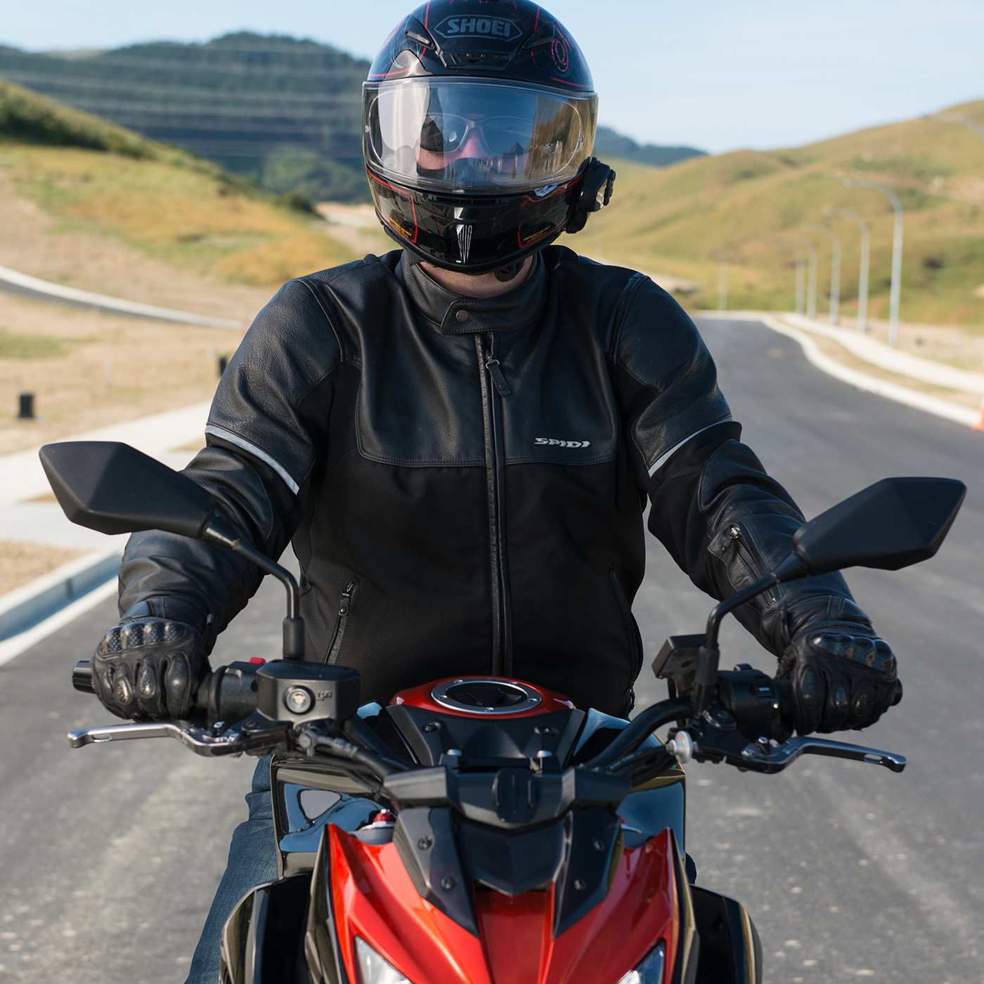 Close up of the front of a street bike with rider